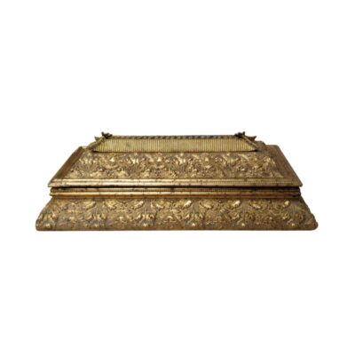 A rectangular chest with a gold finish and lavish embossed patterns featuring plant or leaf motifs across its entire surface, characterised by a stepped lid with an architectural design; available for hire for events, advertising, films and TV series