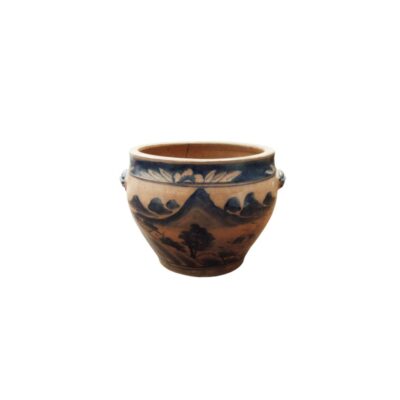 A small, open-top ceramic vessel, characterised by a body that widens towards the top, small ornamental side handles and a delicate painted decoration in shades of blue and white depicting a traditional mountainous landscape with trees and architectural features; available for hire for events, advertising, films and TV series