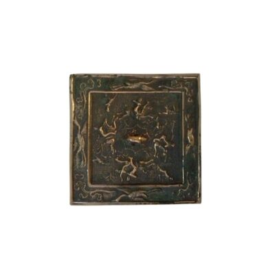 A square metal plaque in an antique style, characterised by a dark patina finish and intricate embossed ornamentation; available for hire for events, advertising, films and TV series