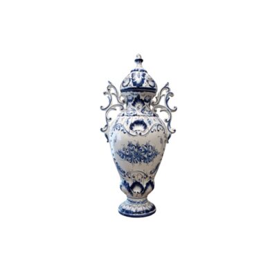 urna cerámica con base de soporte y tapa superior, caracterizada por un cuerpo de fondo blanco decorado con intrincados motivos florales en tonos azul cobalto y elegantes asas laterales curvadas alquiler para eventos, publicidad, peliculas y series