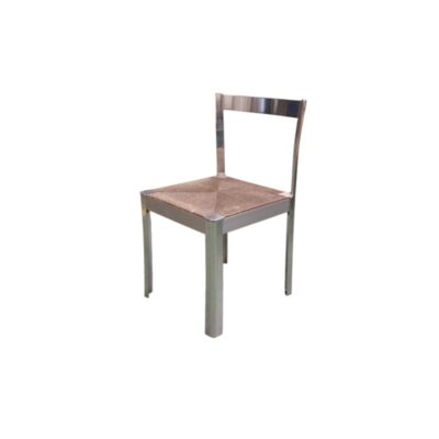 A modern vintage side chair, characterised by a metal frame with straight lines and a shiny chrome finish, and a handcrafted seat upholstered in wicker or natural fibre woven in a geometric pattern. Available for hire for events, advertising, films and TV series.