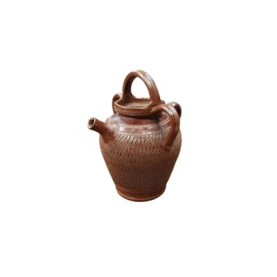 Traditional ceramic jug with a globular body that widens at the top, featuring an elaborate bas-relief incised pattern covering much of its surface with stylised geometric and plant motifs; available for hire for events, advertising, films and TV series