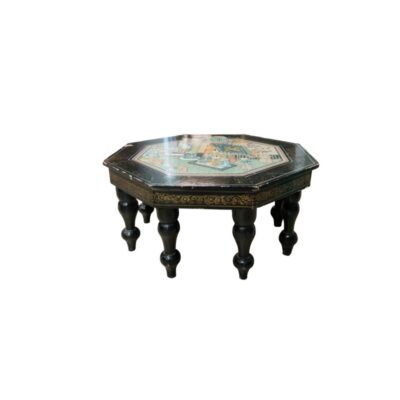 An octagonal coffee table with a dark-coloured finish, featuring a tabletop decorated with a traditionally styled painted scene surrounded by ornamental borders, and sturdy turned legs; available for hire for events, advertising, films and TV series