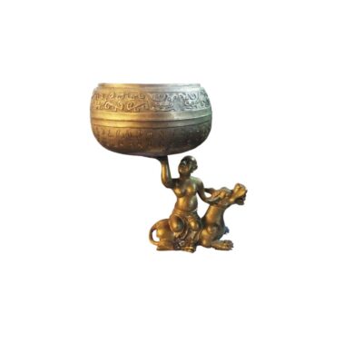 an ornamental bronze sculpture depicting a human figure mounted on a mythical beast, which holds aloft a large vessel with one arm; available for hire for events, advertising, films and TV series