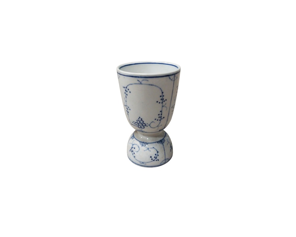 A small ceramic vessel in the shape of a cup or egg cup, characterised by a stylised design with a bulbous base and a flared body against a white background, delicately decorated with fine floral and geometric motifs in shades of cobalt blue; available for hire for events, advertising, films and TV series
