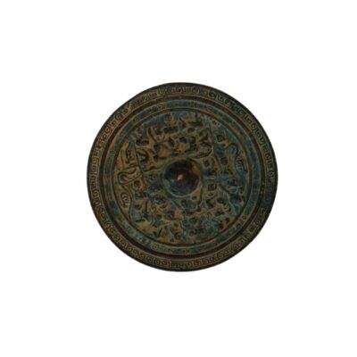 A circular antique bronze mirror with a dark finish and an aged patina, characterised by a densely decorated surface featuring elaborate reliefs of traditional figures and motifs arranged in concentric circles, framed by a geometric border; available for hire for events, advertising, films and TV series