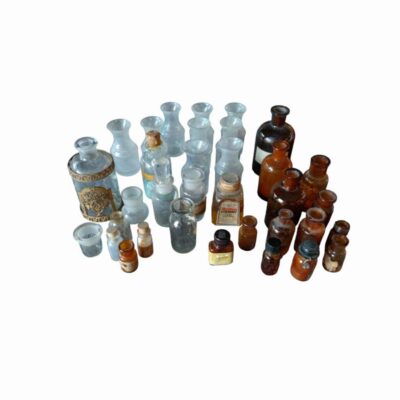 comprising a wide and varied collection of apothecary bottles, small pharmacy jars, inkwells and antique glass containers, dating from around the 1950s; available for hire for events, advertising, films and TV series