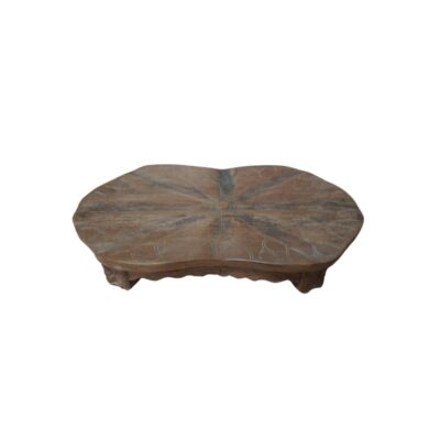 A low wooden table in shades of brown with a rustic finish, characterised by an organically shaped surface with irregular contours that resemble a leaf, decorated with radial carvings representing the central veins and a carved base – available for hire for events, advertising, films and TV series