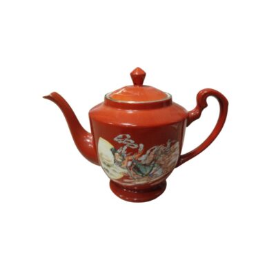 tetera de cerámica con base de pedestal, asa lateral curvada, pico vertedor largo y una tapa a juego provista de pomo, caracterizada por un intenso esmalte exterior en tono terracota alquiler para eventos, publicidad, peliculas y series