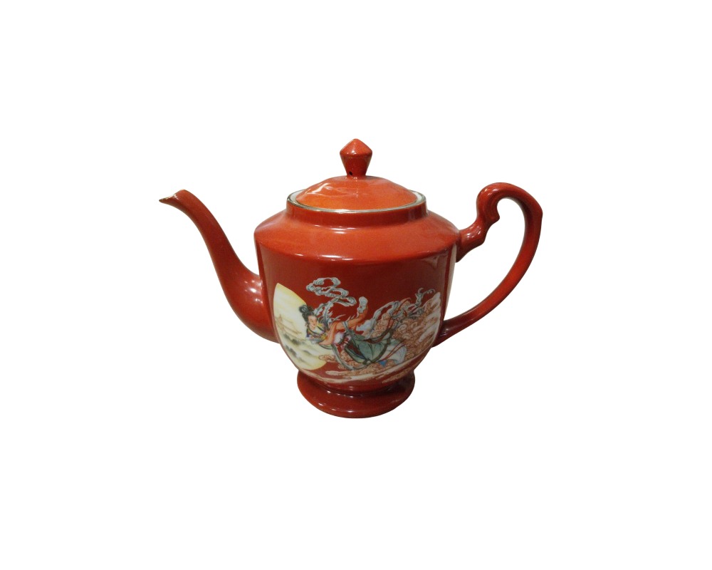tetera de cerámica con base de pedestal, asa lateral curvada, pico vertedor largo y una tapa a juego provista de pomo, caracterizada por un intenso esmalte exterior en tono terracota alquiler para eventos, publicidad, peliculas y series