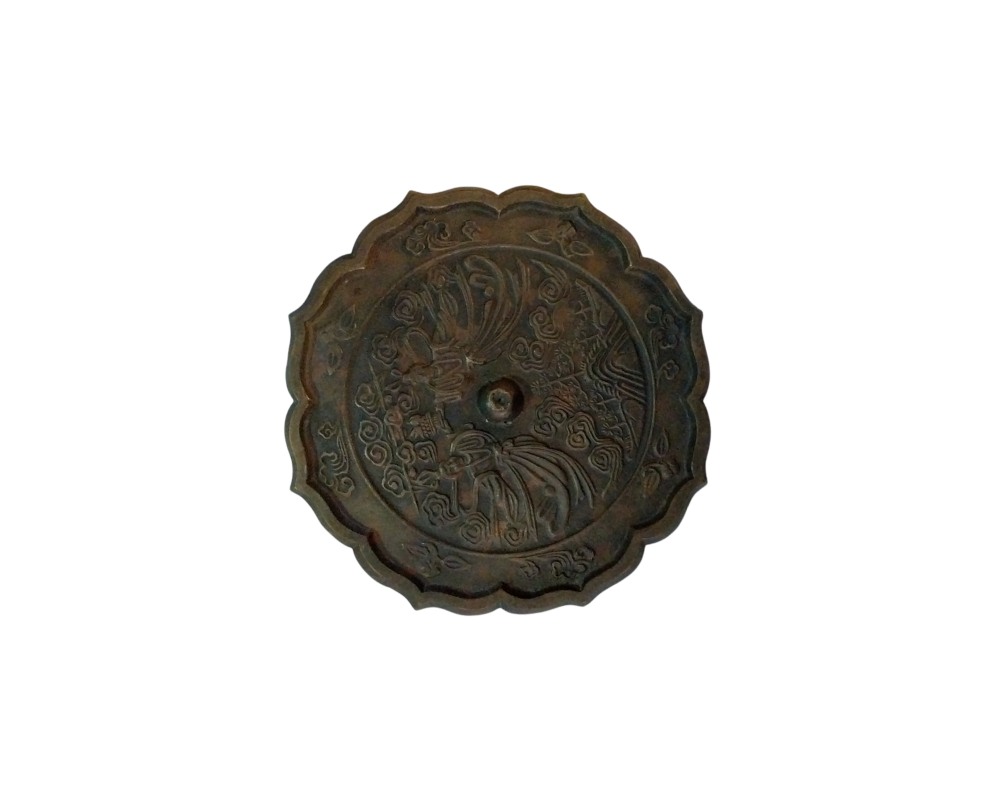Antique bronze mirror with a distinctive lobed edge and a distressed finish in dark tones; available for hire for events, advertising, films and TV series