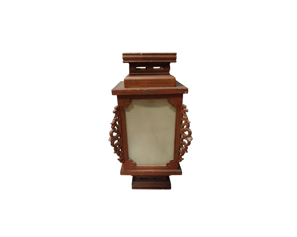 A wooden lantern in shades of brown with a traditional architectural design, characterised by a vertical structure with light-coloured translucent panels on its sides, elaborate side ornaments carved in relief, and stepped bases at both the top and bottom. Available for hire for events, advertising, films and TV series.