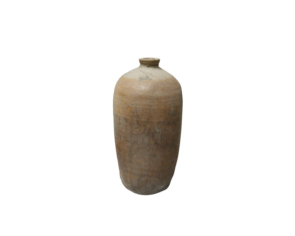 A sturdy, antique-looking ceramic vase, characterised by an elongated cylindrical shape, a narrow neck with a small opening, and a textured surface in earthy tones with signs of wear that reflect its handcrafted nature. Available for hire for events, advertising, films and TV series.