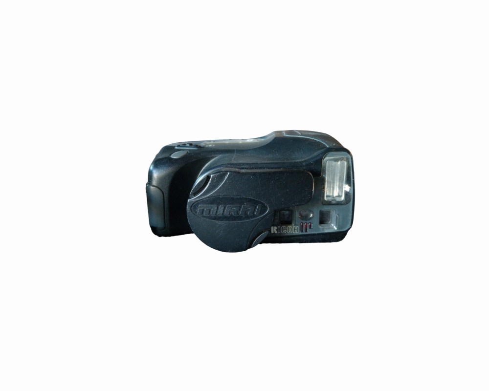 An analogue camera from the renowned Ricoh brand, the Mirai model, characterised by its ergonomic and cutting-edge ‘bridge’ design from the late 20th century; available for hire for events, advertising, films and TV series