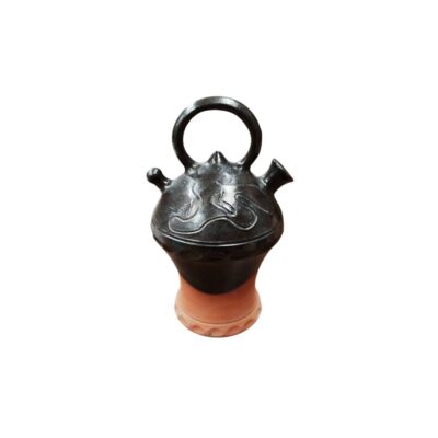 A traditional folk pottery jug with a globular body decorated with incised serpentine motifs, topped with a circular bridge-style handle, a spout resembling a python’s head and a side filling hole; available for hire for events, advertising, films and TV series