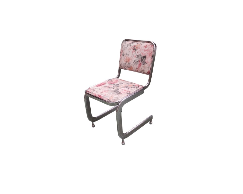 A modern-design side chair, characterised by a continuous cantilevered tubular metal frame (cantilever) with a chrome finish, and a seat and separate backrest, both padded and upholstered in fabric featuring a delicate floral print in shades of pink and grey; available for hire for events, advertising, films and TV series