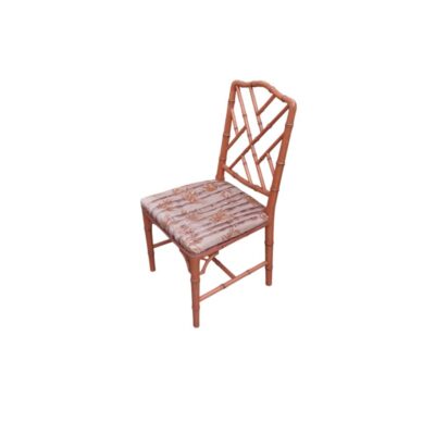 An elegant vintage side chair crafted from natural bamboo, featuring a distinctive backrest with an interlaced geometric design in the Chippendale style and a comfortable, padded seat cushion with botanical-patterned upholstery. Available for hire for events, advertising, films and TV series.