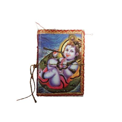Handcrafted notebook in portrait format, featuring a fabric cover decorated with a colourful illustration of a child deity of Hindu inspiration (Krishna) on a floating leaf, framed by gold and red borders, and fitted with a drawstring closure on the side. Available for hire for events, advertising, films and TV series.
