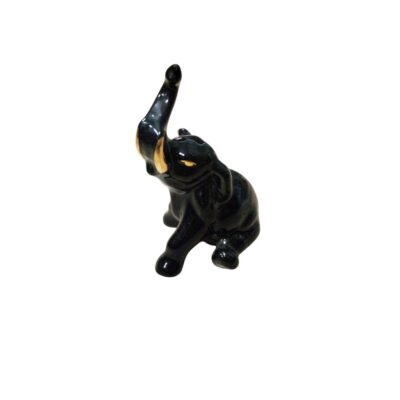 A decorative ceramic figurine depicting an elephant in a dynamic pose, with its trunk raised and tusks prominently displayed; available for hire for events, advertising, films and TV series