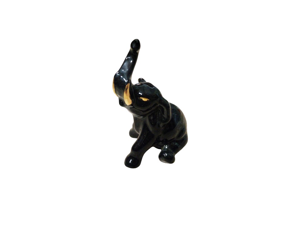 A decorative ceramic figurine depicting an elephant in a dynamic pose, with its trunk raised and tusks prominently displayed; available for hire for events, advertising, films and TV series