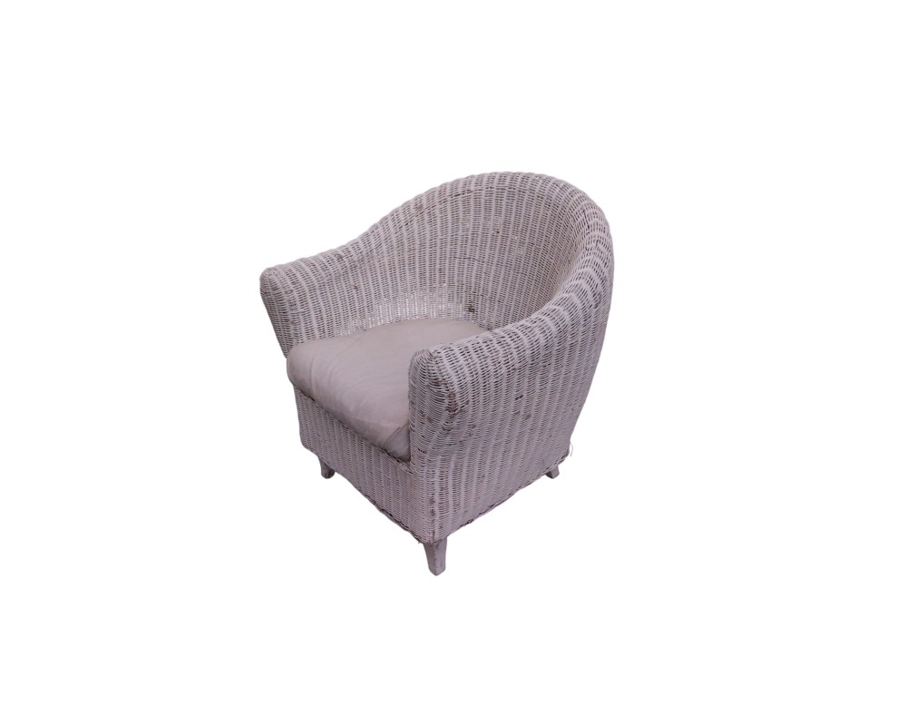 A cosy vintage side chair, made entirely from a wraparound frame of natural wicker and rattan in a white shade; available for hire for events, advertising, films and TV series