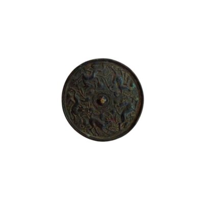 An antique circular bronze mirror, characterised by a dark patina and an elaborate relief on the reverse featuring depictions of animals and plant motifs arranged around a central knob; available for hire for events, advertising, films and TV series