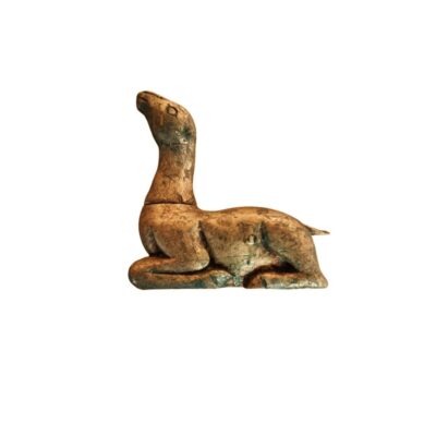 a small sculptural figure depicting a four-legged animal lying down with its neck stretched upwards, characterised by a finish in golden or wood-coloured tones with an aged patina and subtle greenish hues; available for hire for events, advertising, films and TV series