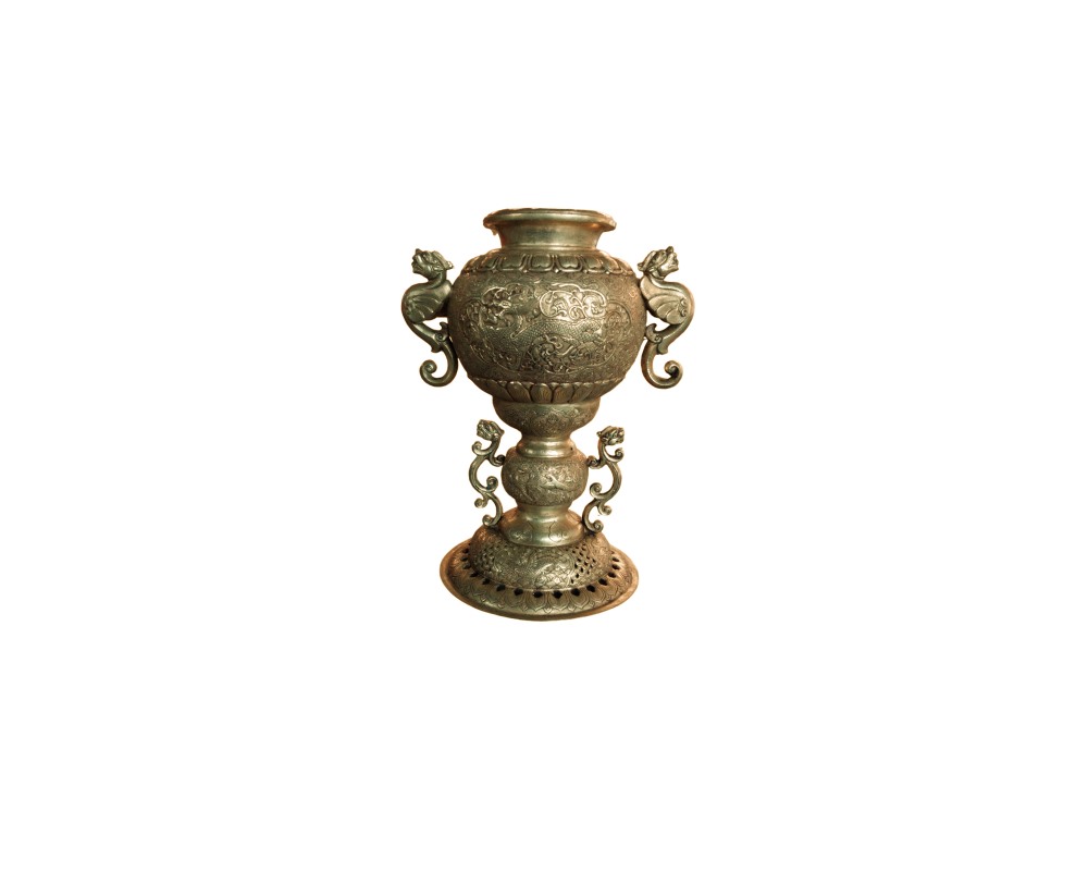 A ritual metal cup with an aged finish, characterised by an elaborate design featuring a domed body, a wide base with decorative perforations, and multiple side handles in zoomorphic and dragon shapes; available for hire for events, advertising, films and TV series