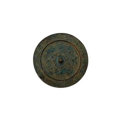 An antique circular bronze mirror, characterised by a dark, greenish patina and an elaborate relief design on the reverse, combining geometric patterns, concentric bands and a square central motif surrounding a central knob; available for hire for events, advertising, films and TV series