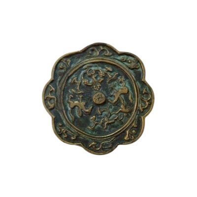 Antique bronze mirror with a distinctive lobed or petal-like design along its outer edge; available for hire for events, advertising, films and TV series