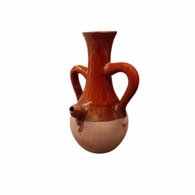 A traditional ceramic jug with a spherical body, the lower half of which is in natural terracotta, whilst the tall neck, shoulders and two symmetrical side handles are covered in a glossy reddish-brown glaze; it also features a small spout at the front. Available for hire for events, advertising, films and TV series.