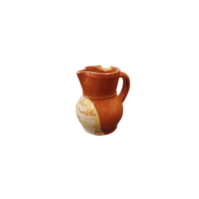 A small ceramic jug with a bulbous body, a side handle and a spout, characterised by a glossy terracotta-coloured glaze and a front panel bearing a handwritten inscription reading ‘Molino Arandilla’ – available for hire for events, advertising, films and TV series