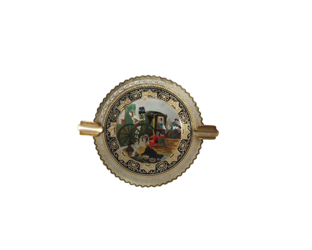 Decorative circular ashtray with scalloped edges and two built-in side holders for cigarettes; available for hire for events, advertising, films and TV series