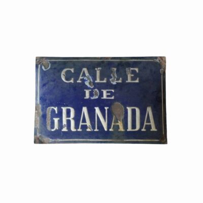 Antique street sign made from enamelled sheet iron, characterised by its classic dark blue background with white lettering and edging; available for hire for events, advertising, films and TV series