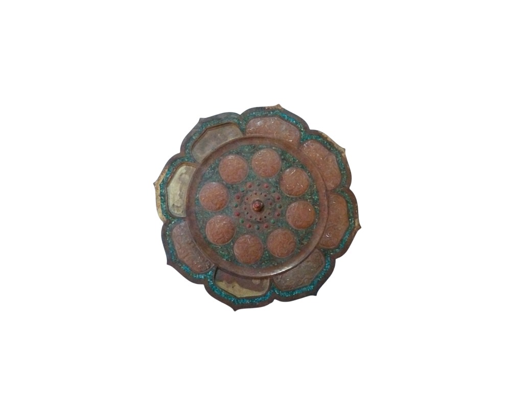 A circular, lobed metal object with an ornamental design reminiscent of a lotus flower; available for hire for events, advertising, films and TV series
