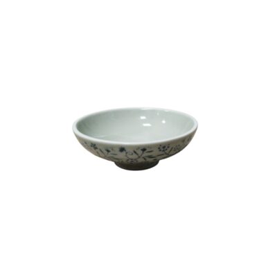 A small ceramic bowl with an open profile and an elegant ring-shaped base, characterised by a light-coloured glaze on the inside and delicate exterior decoration featuring small flowers and intertwined stems in shades of cobalt blue. Available for hire for events, advertising, films and TV series.