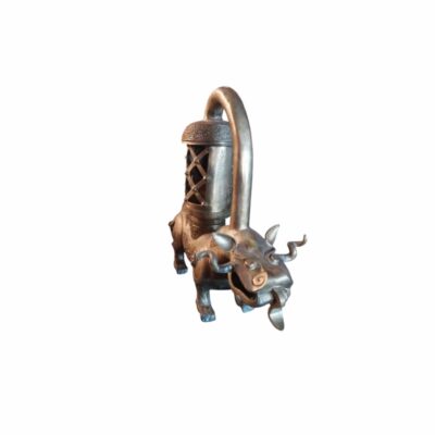 an ornamental metal sculpture depicting a mythical creature with a sturdy appearance and curved horns, connected by an arched tube to a vertical cylindrical structure resembling a lantern; available for hire for events, advertising, films and TV series