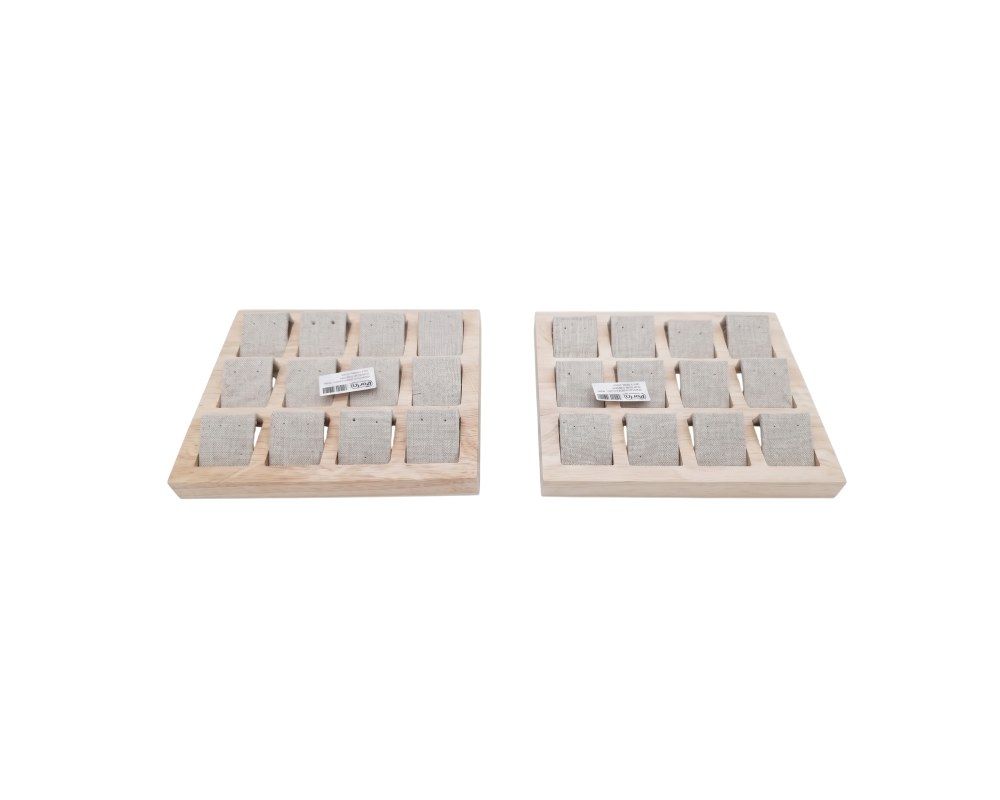 This set comprises two square display trays with a light-coloured wooden outer frame and multiple individual compartments lined with textured linen fabric; available for hire for events, advertising, films and TV series