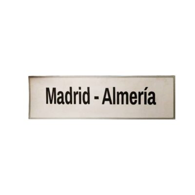 A light-coloured, rectangular sign in landscape format bearing the inscription ‘Madrid – Almería’ in black lettering, characteristic of the classic signage used for passenger transport, hire for events, advertising, films and TV series