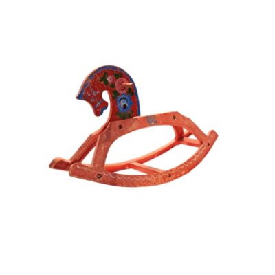 A toy rocking horse made from wood in shades of red and orange, featuring a head decorated with hand-painted floral motifs in shades of blue, white and green against a dark background; available for hire for events, advertising, films and TV series