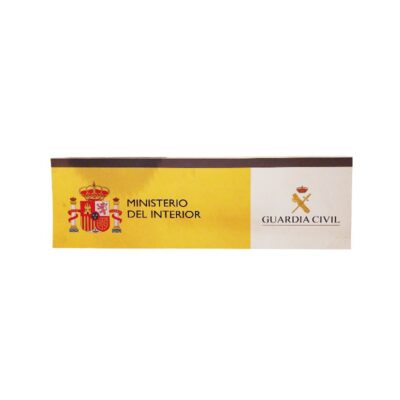 a rectangular sign in landscape format with a two-colour design, showing on the left-hand side the national coat of arms alongside the text ‘MINISTRY OF THE INTERIOR’ on a yellow background, and on the right-hand side, the emblem and the inscription ‘GUARDIA CIVIL’ on a white background. Available for hire for events, advertising, films and TV series.