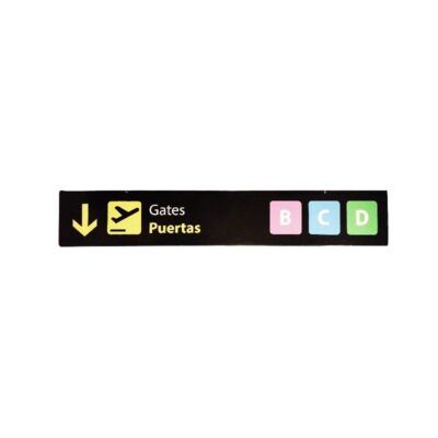 a rectangular sign in landscape format with a dark background, featuring a downward-pointing arrow, an aviation pictogram, the bilingual text ‘Gates / Puertas’ and boarding gate symbols in coloured boxes for the letters B, C and D. Available for hire for events, advertising, films and TV series
