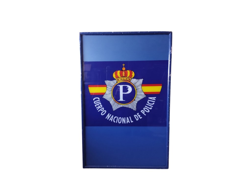 A rectangular, portrait-format sign with a metal frame and a blue background, featuring the official emblem and the crown of the National Police Force in the centre, with the inscription ‘CUERPO NACIONAL DE POLICIA’ in an arched design; available for hire for events, advertising, films and TV series