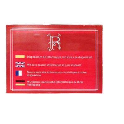 A rectangular sign in landscape format with a red background, a light-coloured border and a monogram at the top, displaying information on the availability of tourism data translated into several languages (Spanish, English, French and German), accompanied by small flags representing hire for events, advertising, films and TV series
