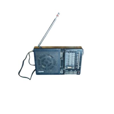 A Sony-branded portable radio in a landscape format, characterised by its dark-coloured casing, the front speaker grille, side-mounted slide switches, a multi-band tuning dial (FM/MW/SW) and a built-in metal telescopic antenna. Available for hire for events, advertising, films and TV series.