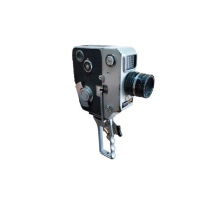 A vintage analogue Chinon film camera, characterised by its sturdy body featuring a combination of silver tones and a dark textured finish, circular mechanical controls and an integrated vertical metal grip; available for hire for events, advertising, films and TV series