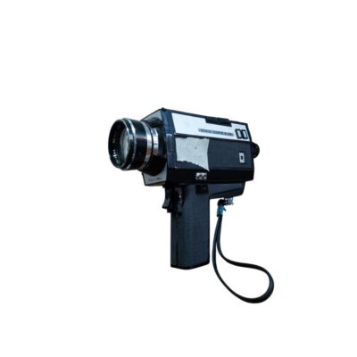 A Revue-brand Super 8 analogue film camera, characterised by its classic, compact body in dark colours, an integrated pistol-grip and a prominent front lens with metal rings; available for hire for events, advertising, films and TV series
