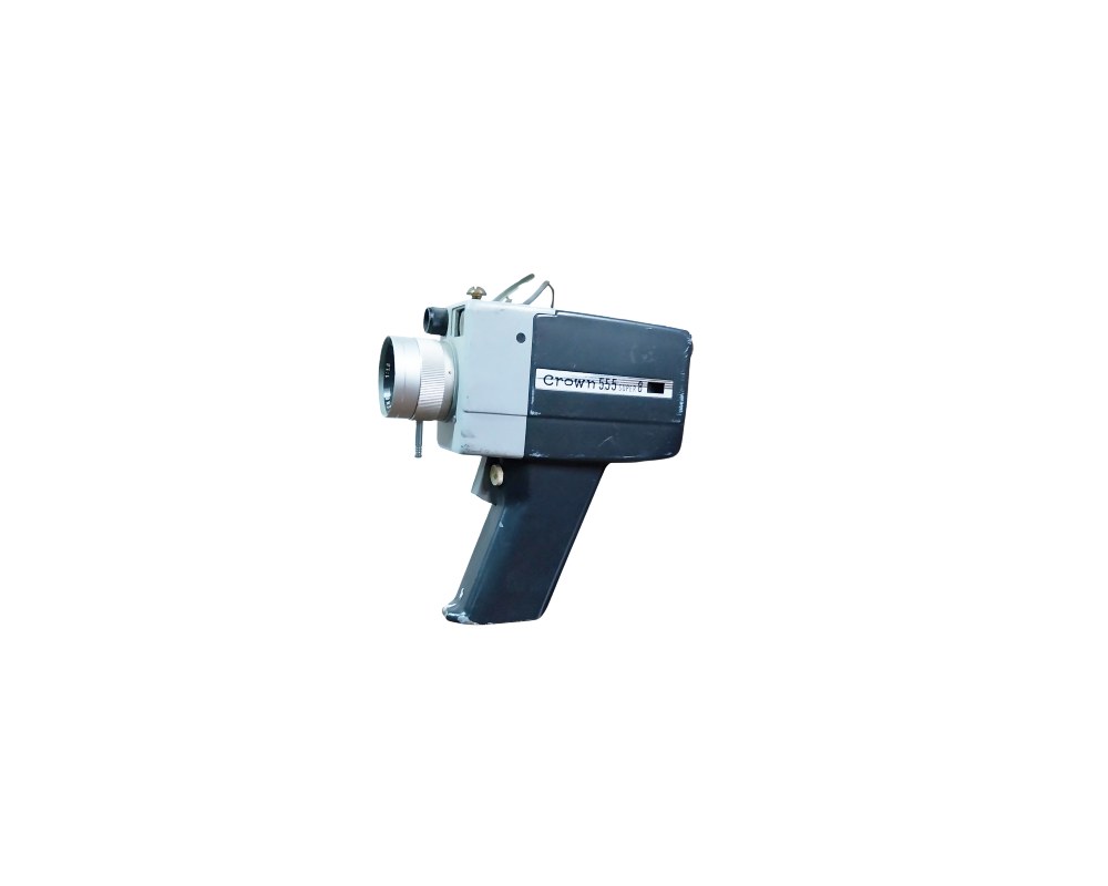 A vintage Crown Super 8 analogue film camera, model 555, characterised by its horizontal body in shades of grey and black, a prominent metal front lens and an ergonomic vertical pistol-grip handle; available for hire for events, advertising, films and TV series