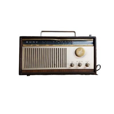 Sony portable radio, characterised by its wood-effect framed body, a metal front panel with a vertical speaker grille, rotary controls and a metal handle on top; available for hire for events, advertising, films and TV series