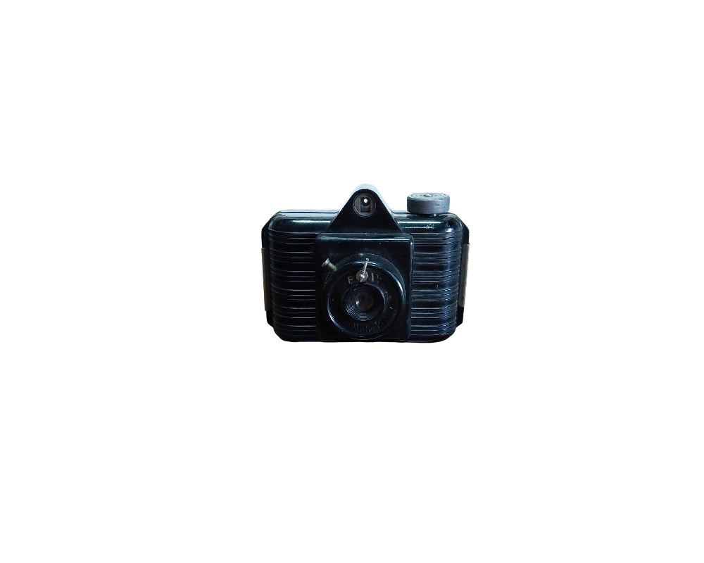 A classic analogue camera made from black bakelite with a ribbed design on the sides, an integrated top viewfinder and a protruding central lens; available for hire for events, advertising, films and TV series